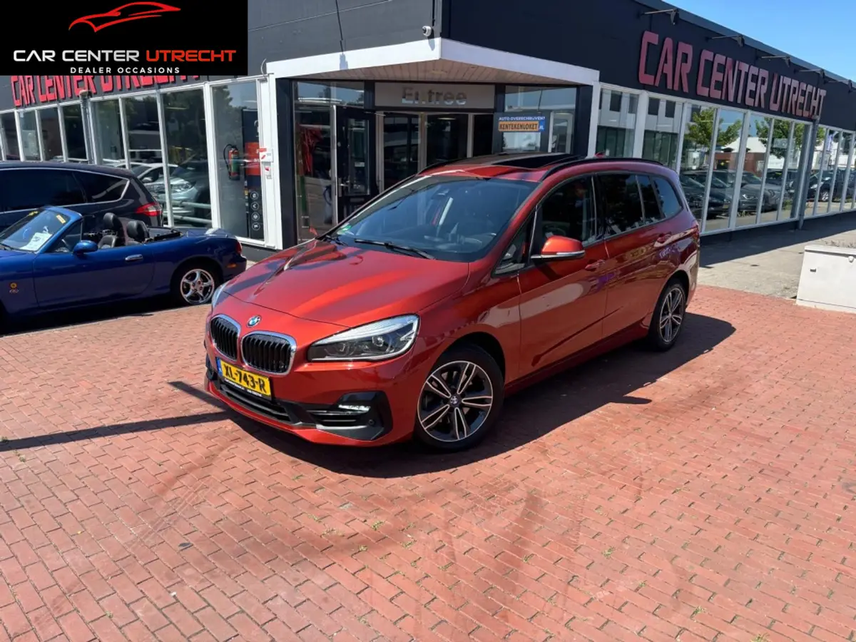 BMW 2 Serie Gran Tourer 218i High Executive oranje metallic |trekhaak|automaat|: foto 1