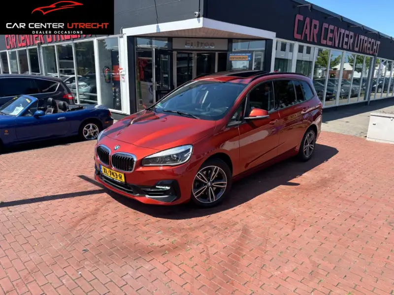 BMW 2 Serie Gran Tourer 218i High Executive oranje metallic |trekhaak|automaat| 2019 leasen bij DreamLease: foto 1